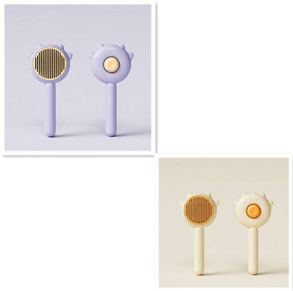 Cat Comb Hair Removal Brush in lavender and cream colors, designed for grooming cats and dogs.