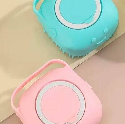 Silicone dog bath massage brush with shampoo dispenser for pet grooming, featuring soft bristles and ergonomic handle.