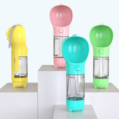 Portable 3-in-1 dog water bottle, travel feeder, and waste bag holder for pet travel and outdoor walks.