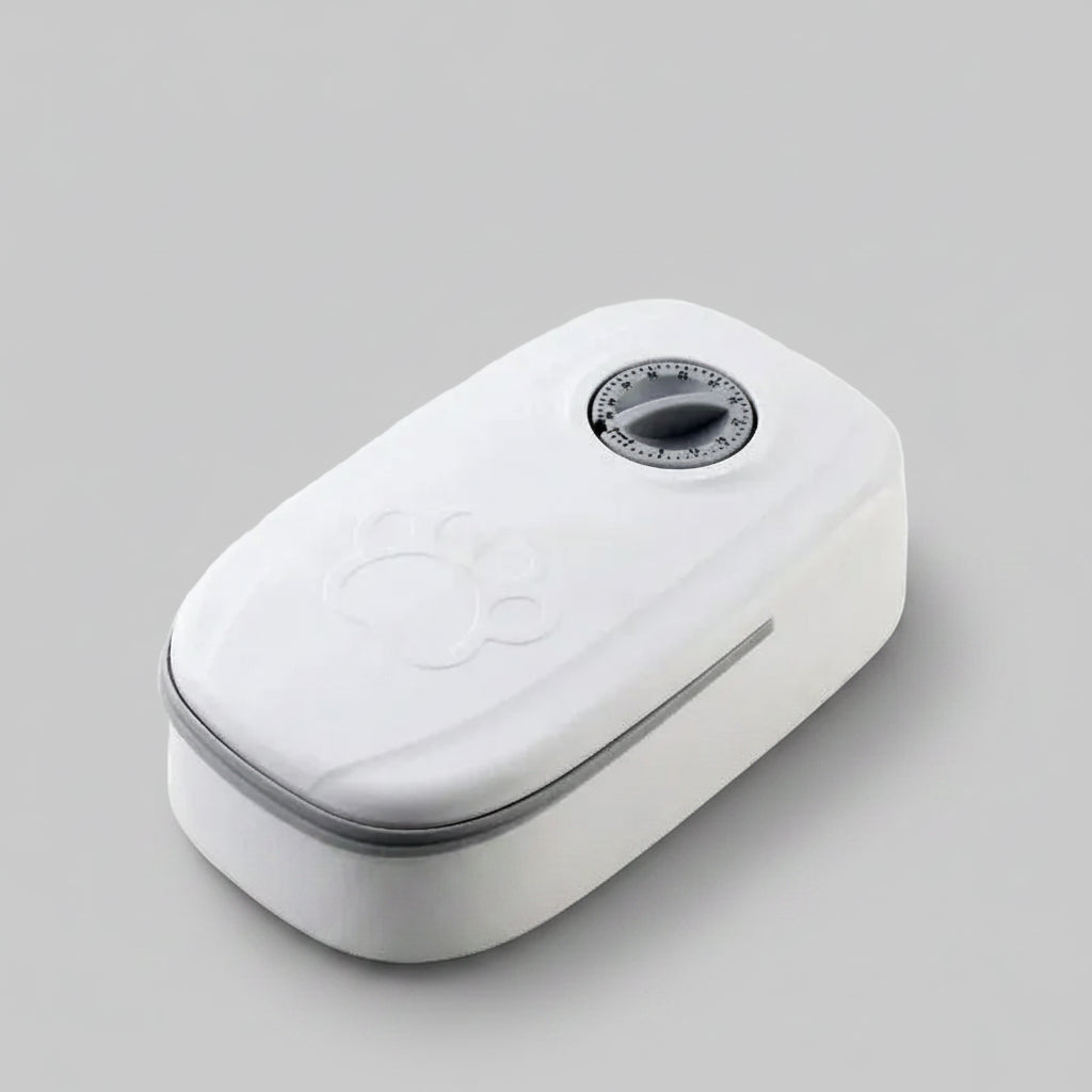 A white automatic pet feeder with a digital timer dial on top and an embossed paw print, shown on a plain white background.